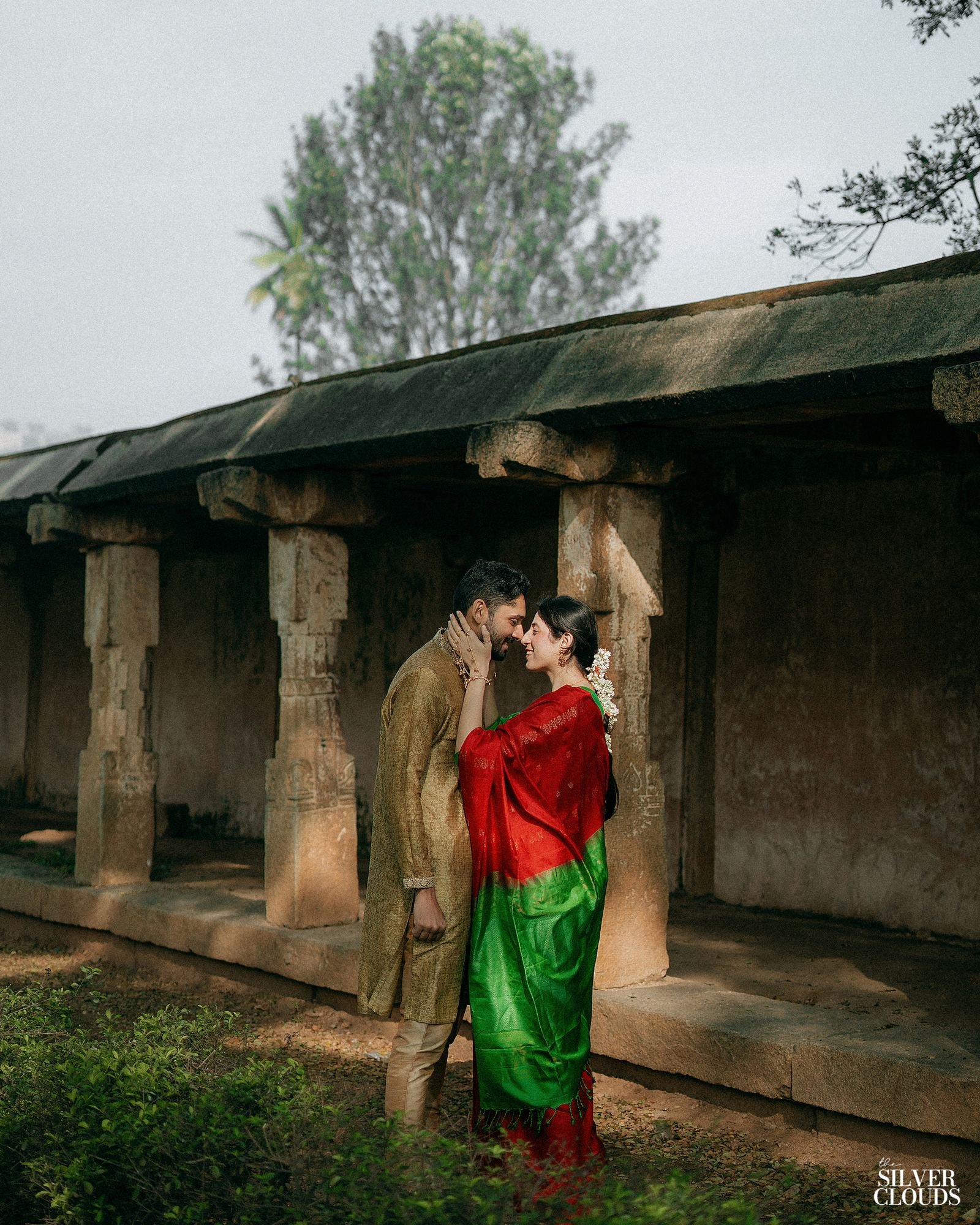 A couple at the edge of a colonnade, late afternoon