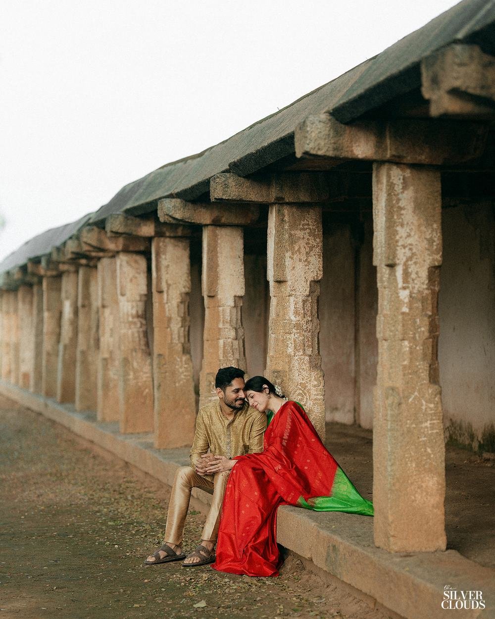Seated in the shade of the colonnade, the stone running away behind them