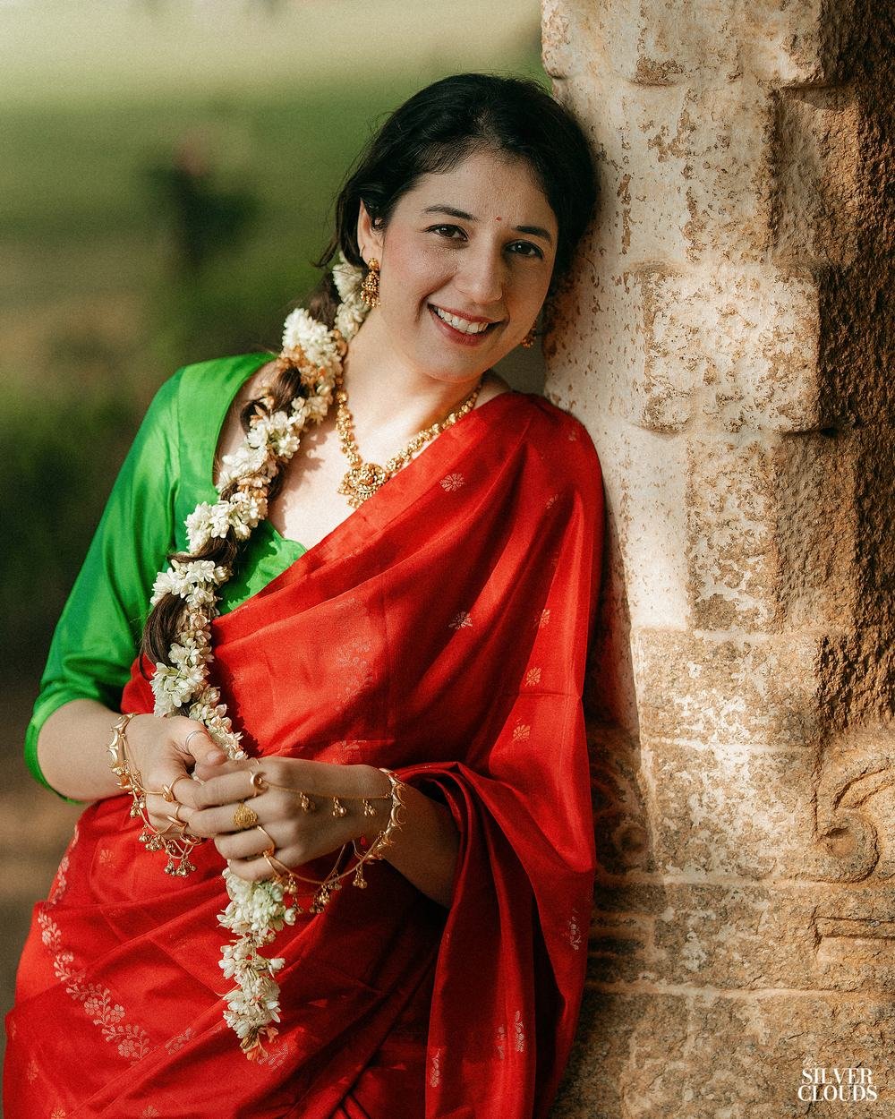 A portrait against warm stone, jasmine in her hair