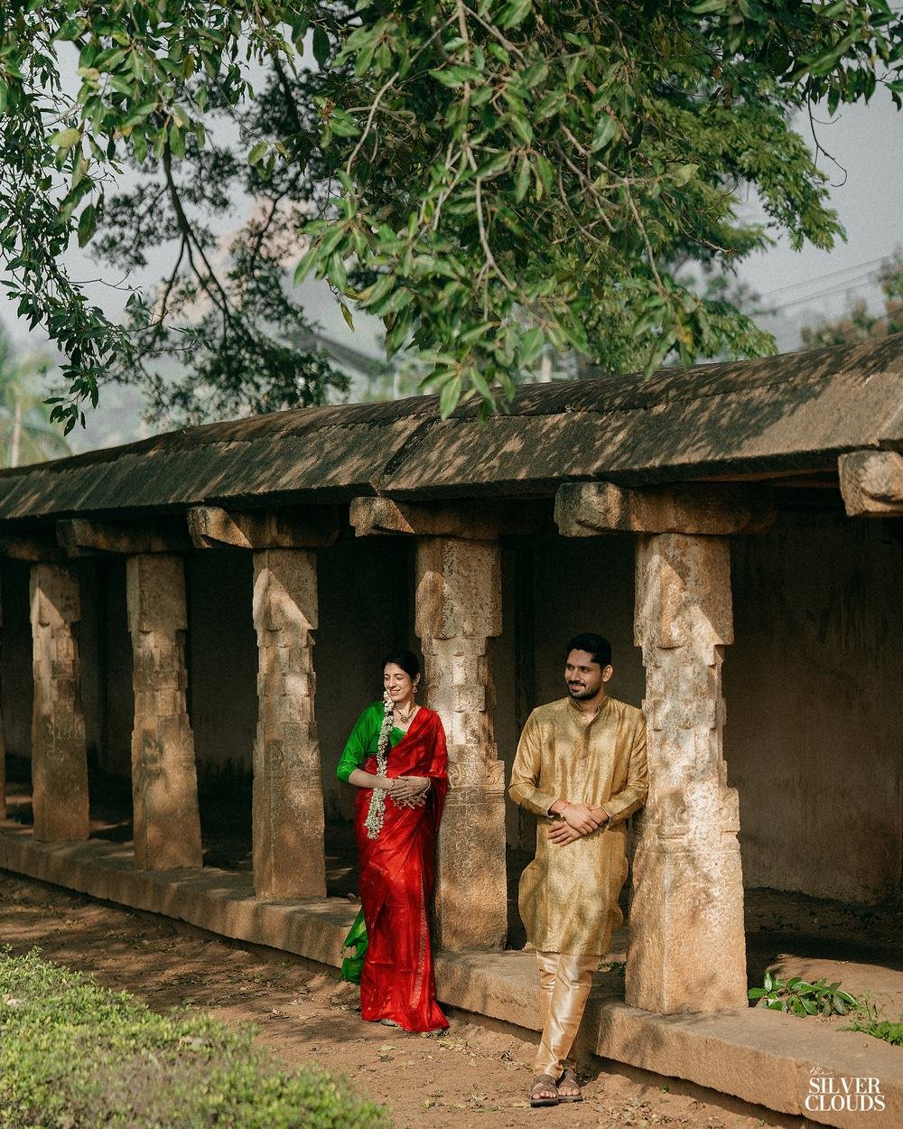 The full length of the colonnade, the two of them small inside it