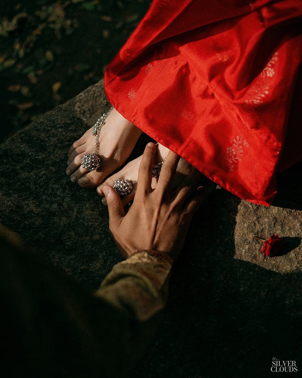 Two hands and a fold of silk against the rock